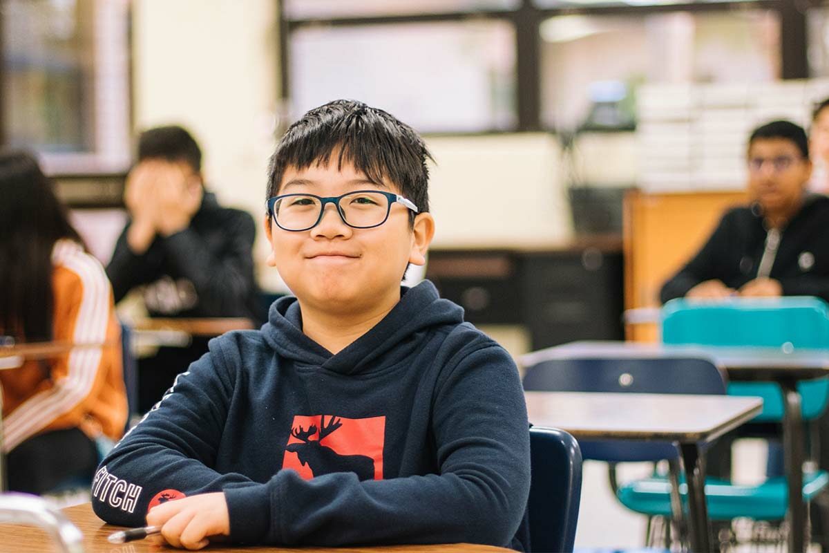 student sitting at desk in classroom